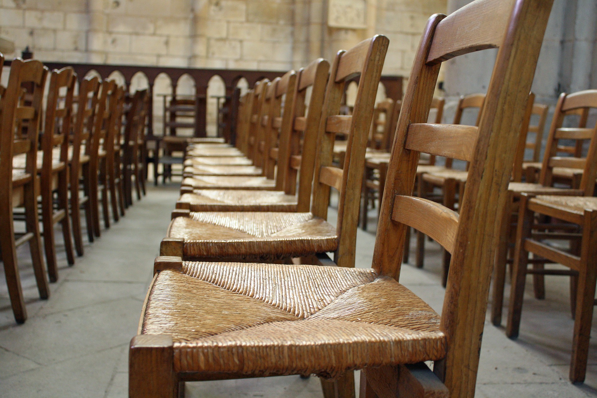 Photo of a row of empty wooden chairs