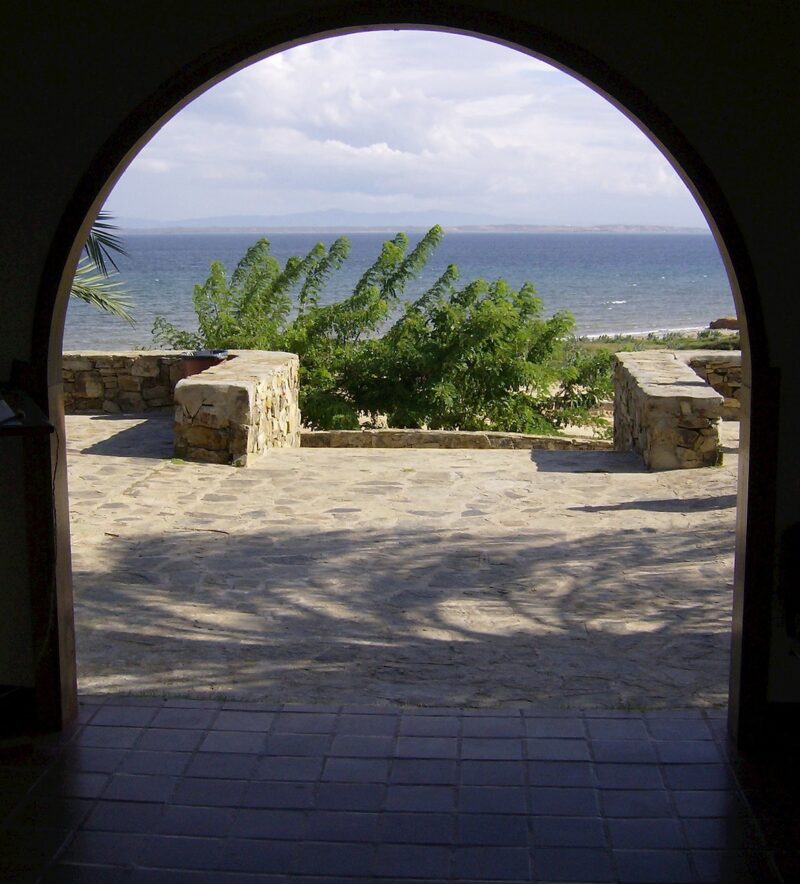 Photo of a balcony overlooking the ocean through a doorway
